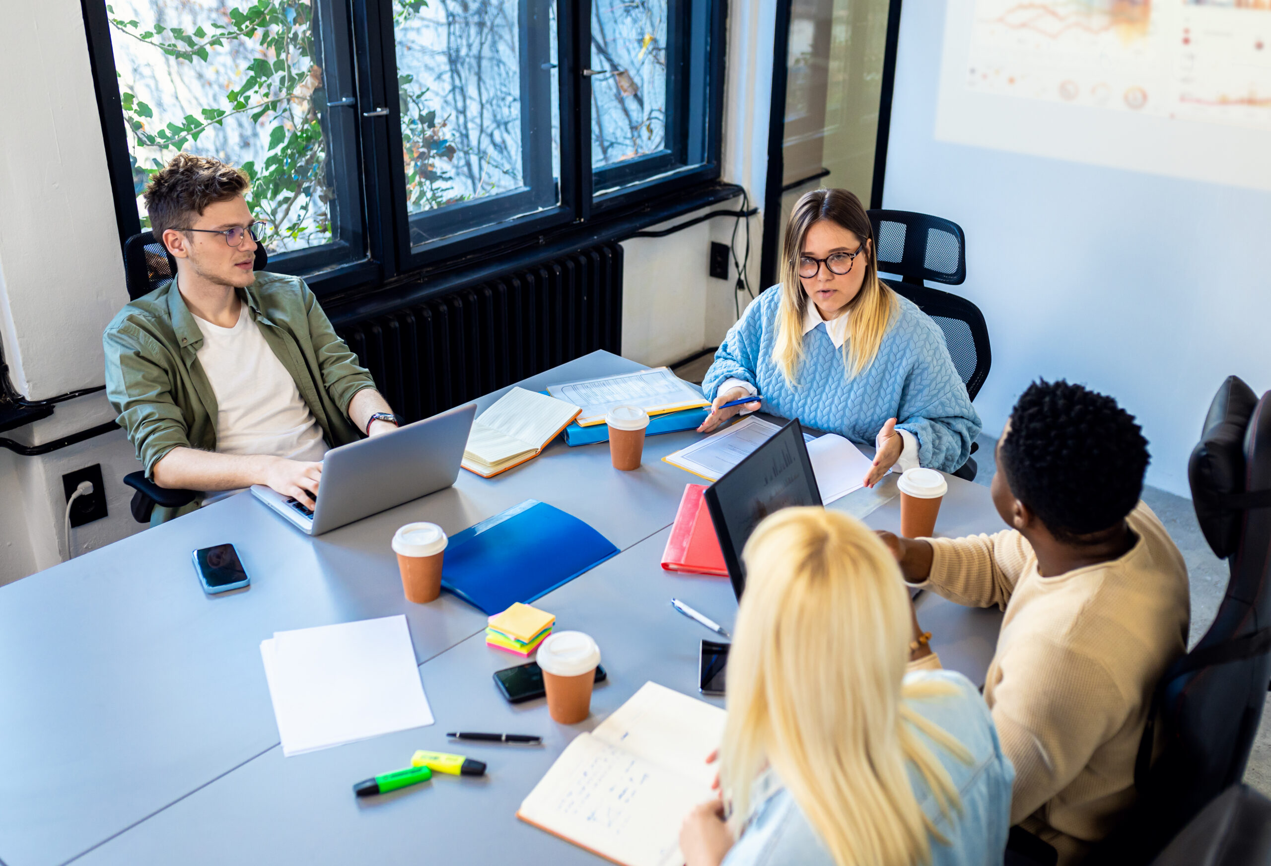 A team collaborating during a marketing internship meeting in a modern office.
