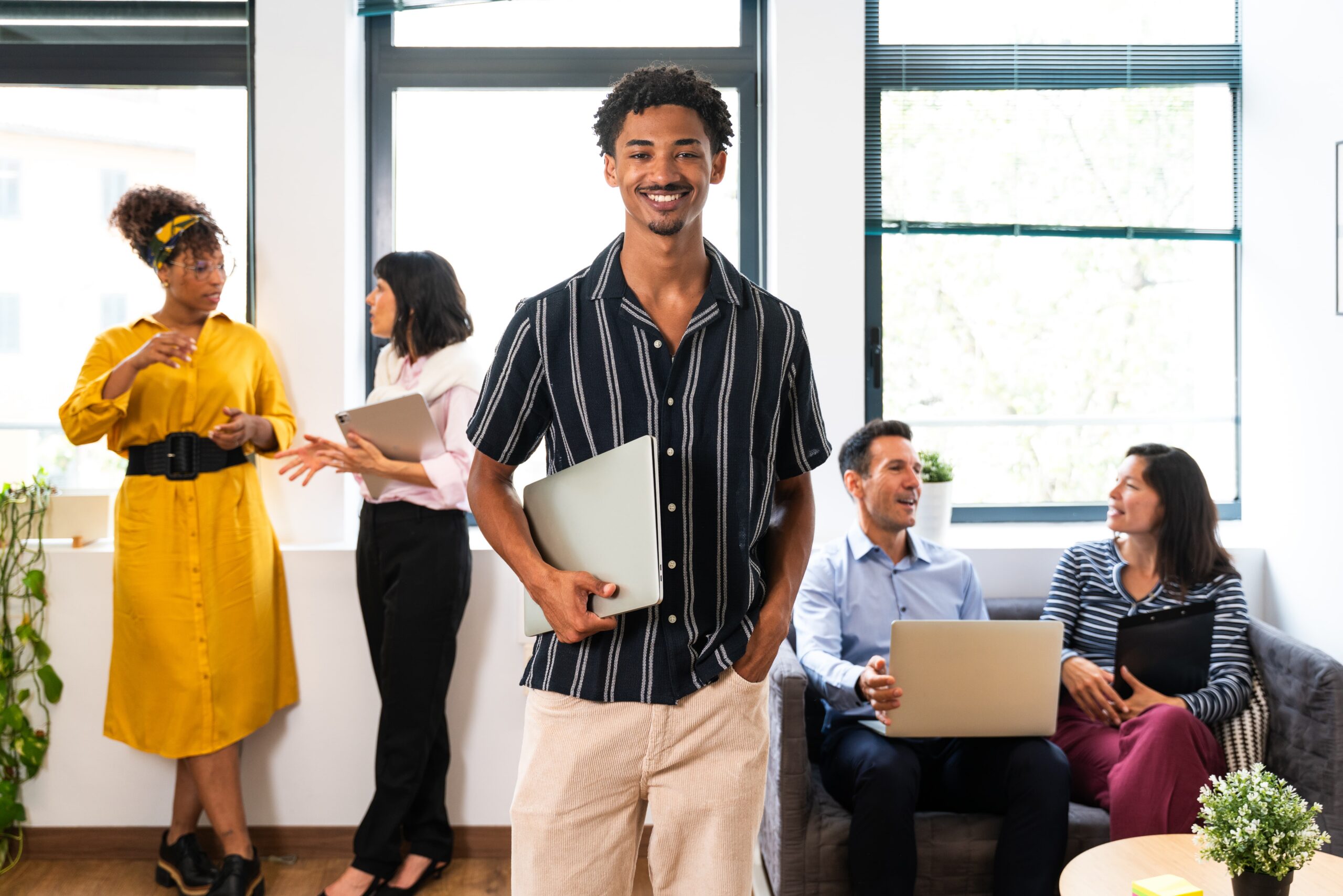 Young professional beginning a full-time job while collaborating in a modern office environment.